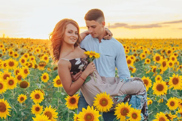 loving couple in field of sunflowers
