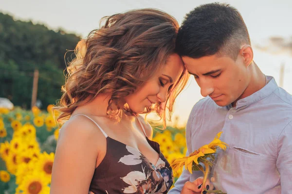 loving couple in field of sunflowers