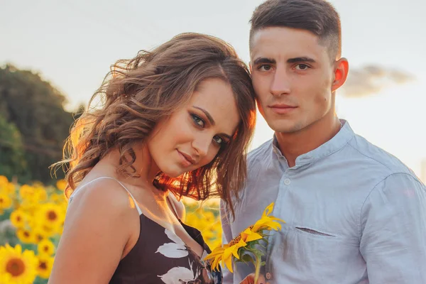 loving couple in field of sunflowers