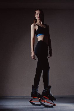 Genç kız Kangoo ayakkabı ile egzersiz. beden eğitimi ve spor güzel kız. Kangoo atlama. Spor eğitim Kangoo atlama içinde güzel kızlar