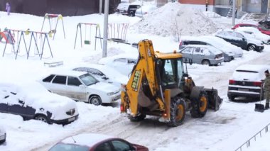 Şehirde kar yağışlı bir günde traktör temizliği. Kış Servis Aracı iş başında. Kar Kaldırma Aracı