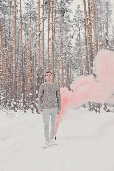 Temperature, freezing, cold snap. Bearded man smoking cigarette with skates in snowy forest. Man in thermal jacket, beard warm in winter. Winter sport, Christmas. skincare and beard care in winter.