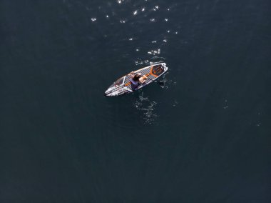 Stand Up Paddle tahtasında çekici bir kadın yemek masasında kürek çeken ve şeffaf suyun tadını çıkaran bir kadın. Tropik seyahat, seyahat tutkusu ve su aktivitesi konsepti. Gün batımı ve rahatlama
