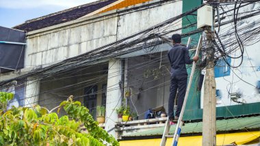 Merdiven üzerinde duran elektrikçi 