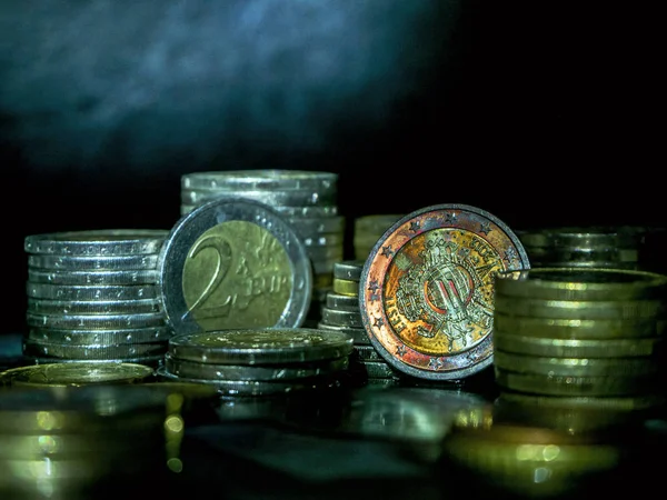 Euro coins on the table  Coin stack with rising chart line, being spotted with scope Stack Euro coins - money