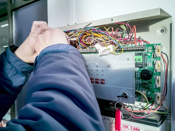 Bir kask içinde bir elektrikçi elektrik kutusu devre kesiciler teller bağlanır. Nitelikli bir mühendis bir elektrik pano içinde çalışır. Yüksek gerilim donatımı işçi onarır. 