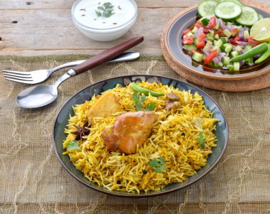 Spicy and Mouth Watering Chicken Biryani, prepared Chicken and full of spices clipart