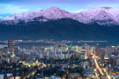 View of residential and office buildings at the wealthy district of Las Condes in Santiago de Chile with Los Andes Mountain Range in the bac clipart