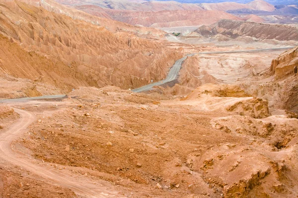 Road in the Atacama desert between salt formations at Valle de la Luna, spanish for Moon Valley, also know as Cordillera de la Sal, spanish for Salt Mountain Range, San Pedro de Atacama, Atacama desert, Chile, South America