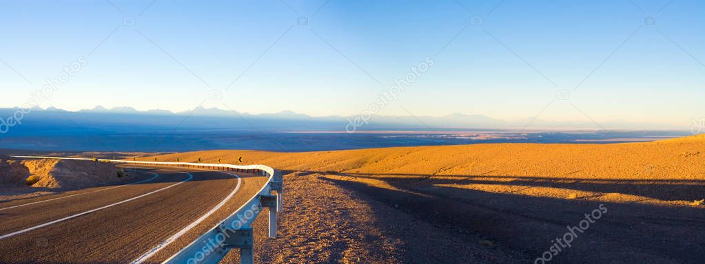 Access road and panoramic view of Atacama Salt Lake (Salar de Atacama) and San Pedro de Atacama village, Atacama Desert, Chile