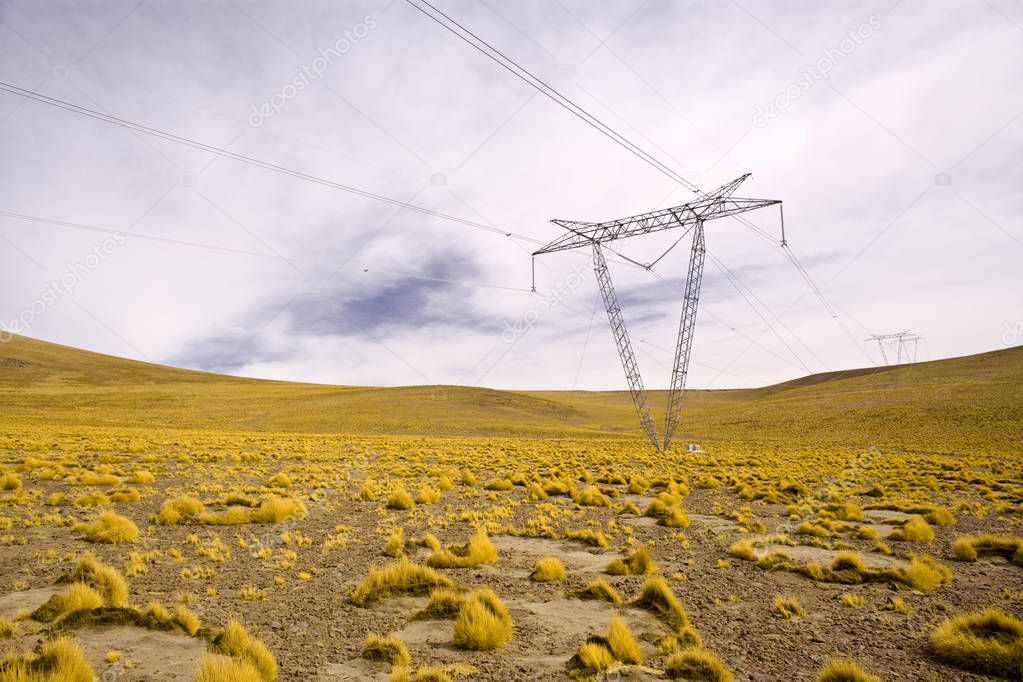 Power lines towers in the Altiplano (high Andean plateau) at 4200 meters over the sea level, Atacama desert, Antofagasta Region, Chile, South America