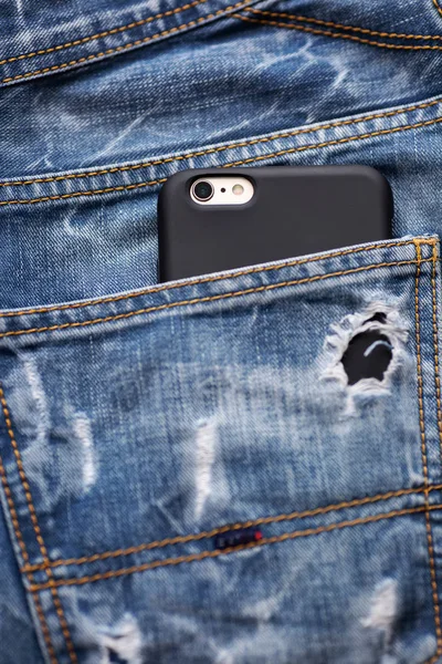 Mobile phone in jeans pocket