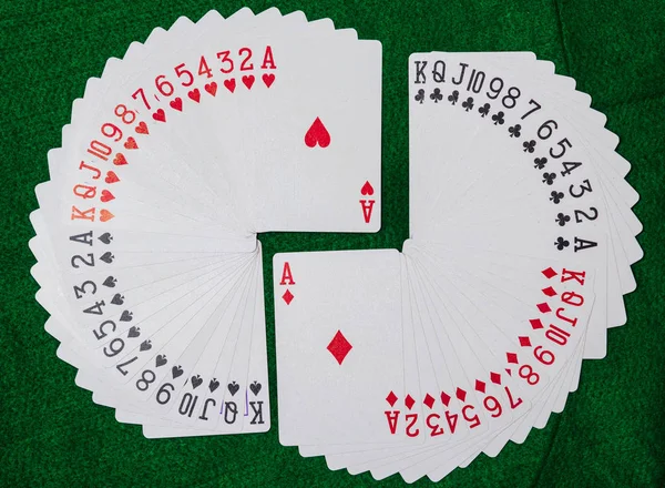 Deck of playing cards,  thirteen ranks in each of the four suits, clubs, diamonds, hearts and spades.