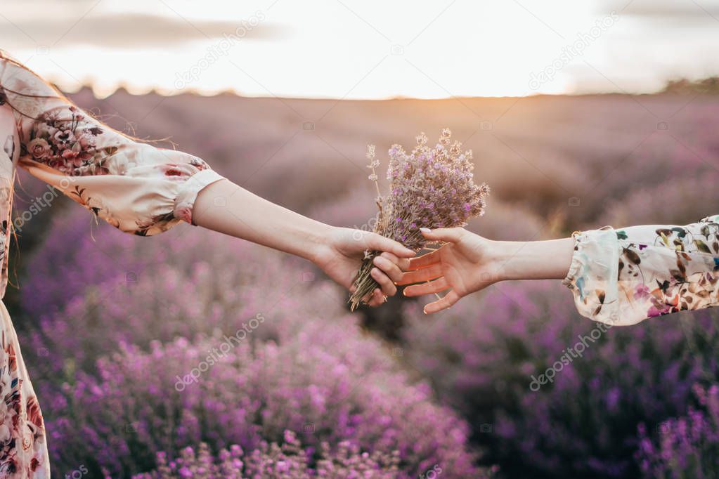 friends holding bunch of lavender 