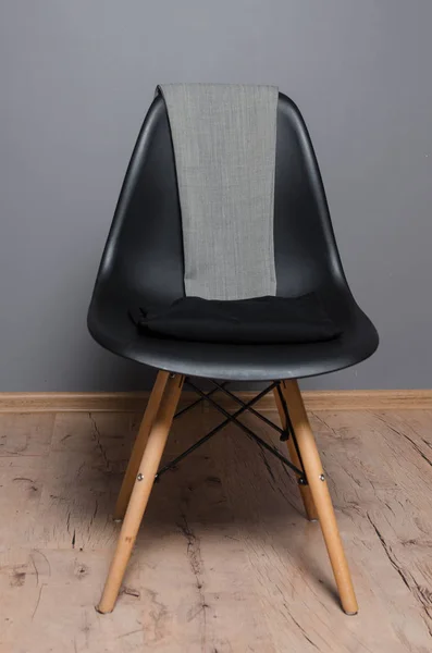 black chair with clothes