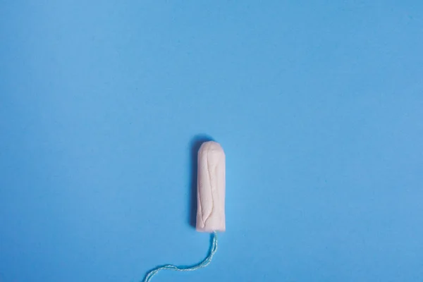 Menstruation tampon on blue background — Stock Photo, Image