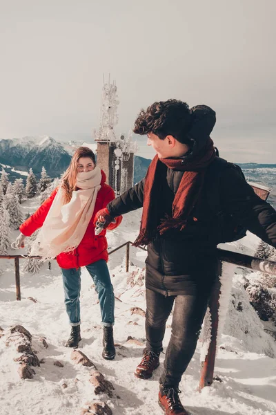 guy with girl  climb mountain