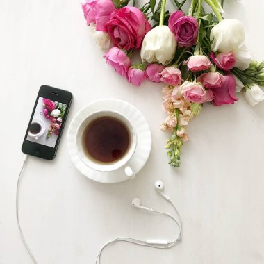           siyah akıllı telefon ve çiçekli çay.