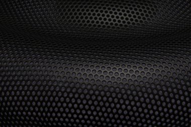 Bir perfora şeklinde çok renkli arka plan delik dalgalı eğri yüzeyli metal delikli. Bükülmüş bir levha metal yuvarlak küçük delikler şeklinde arka plan. Delikli örgü. Deliklerden ışık