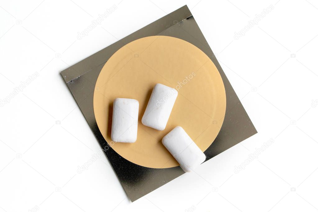 Nicotine patch and chewin gum used for smoking cessation isolated on white background