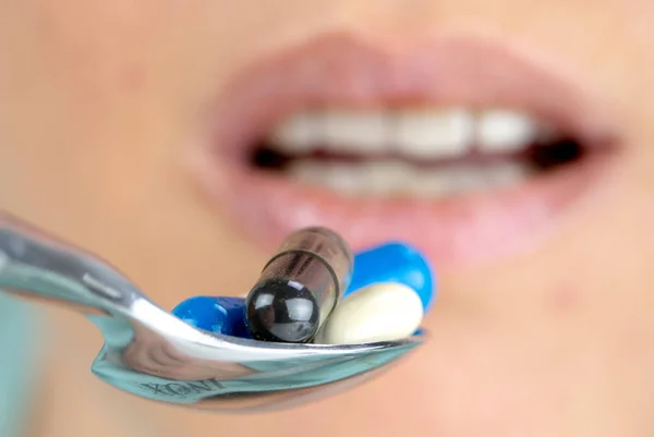 Close Woman Eating Lot Colorful Pills Spoon — Stock Photo, Image
