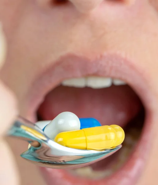 Close Woman Eating Lot Colorful Pills Spoon — Stock Photo, Image