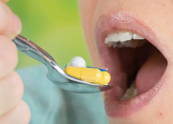 Close Woman Eating Lot Colorful Pills Spoon — Stock Photo, Image