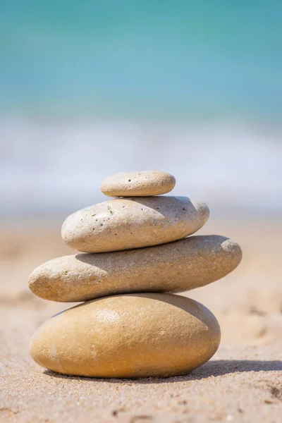 Pyramid of stones for meditation lying on sea coast at sunset. Meditation abstract concept