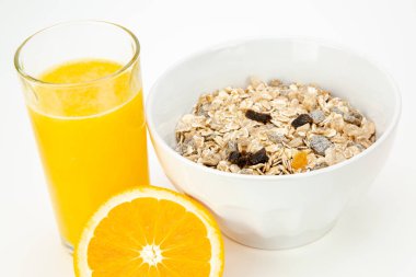 Delicious balanced breakfast with a bowl of muesli and fresh orange juice