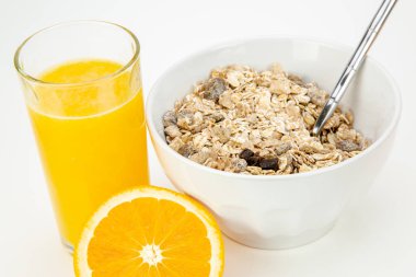 Delicious balanced breakfast with a bowl of muesli and fresh orange juice