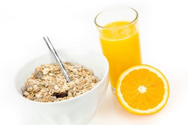 Delicious balanced breakfast with a bowl of muesli and fresh orange juice