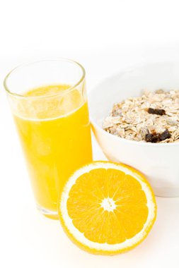 Delicious balanced breakfast with a bowl of muesli and fresh orange juice