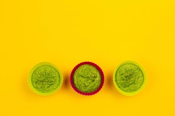 Trio of broccoli cake on a yellow background. Top view.