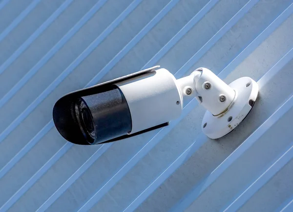 Modern CCTV camera on the wall of an industrial building Stock Picture