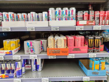 Puilboreau, France - October 14, 2020:Varied range of energy drink cans with leading brands such as red bull, coca cola energy and lesser known brands punch, spring up, juiced monster display for sell in the supermarket shelves clipart
