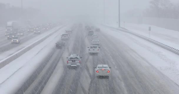 Cars driving on a snow covered road — Stock Video