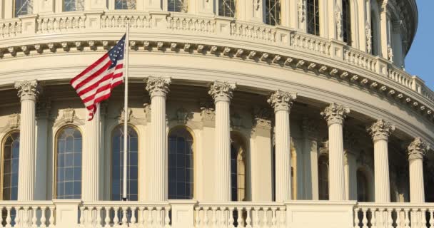 American flag flies by the Capitol building in Washington DC USA — Stock Video