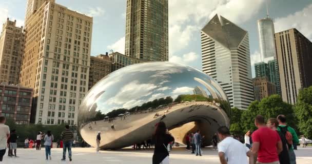 People gather around the Cloud Gate Bean and Chicago Skyline in summer — Stock Video