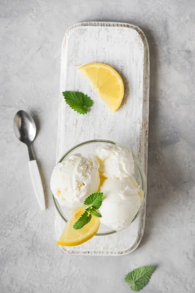 Lemon Ice Cream in bowl. Homemade citrus lemon ice cream with mint close up.