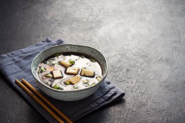 Japon miso çorbası kopya alanı siyah taş masada seramik kase. Asya miso çorbası ile tofu.