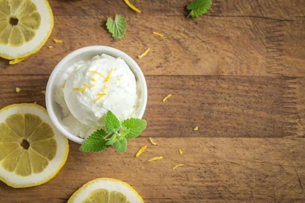 Lemon Ice Cream in bowl. Homemade citrus lemon ice cream (gelato) with mint close up.
