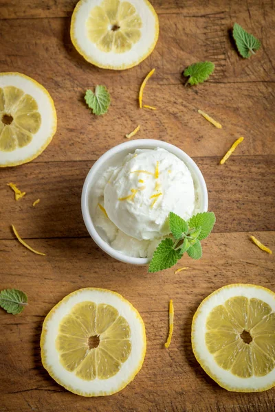 Lemon Ice Cream in bowl. Homemade citrus lemon ice cream (gelato) with mint close up.