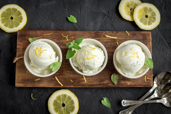 Lemon Ice Cream in bowl. Homemade citrus lemon ice cream (gelato) with mint close up.