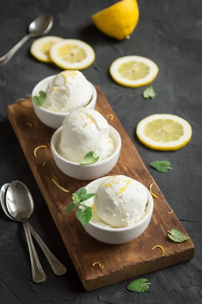 Lemon Ice Cream in bowl. Homemade citrus lemon ice cream (gelato) with mint close up.