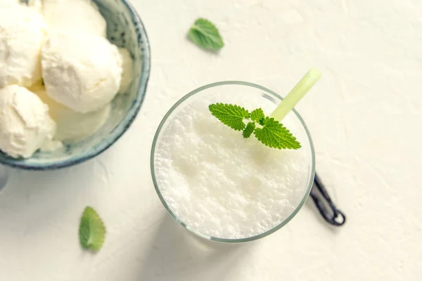 Vanilla Shake with Ice Cream and Mint on white background. Vanilla Ice Cream Milk Shake. Banana Smoothie with Mint and Vanilla.