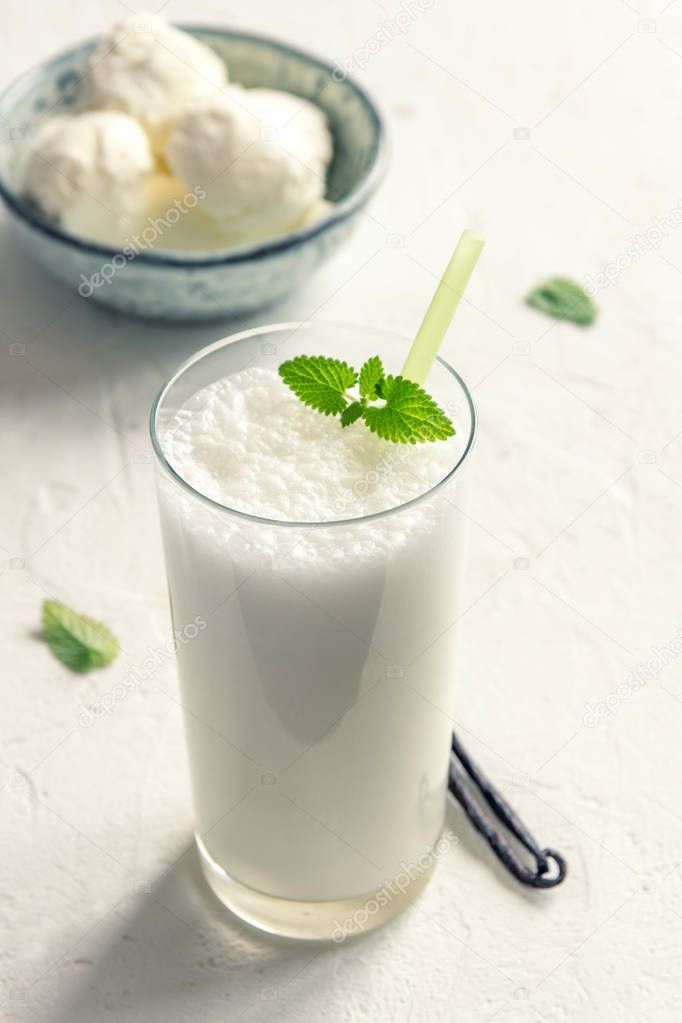 Vanilla Shake with Ice Cream and Mint on white background. Vanilla Ice Cream Milk Shake. Banana Smoothie with Mint and Vanilla.