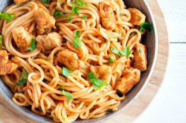 Domates soslu tavuk, maydanoz tavada spagetti makarna. Tavuk spagetti makarna kopya alanı, Italyan Mutfagi ile beyaz ahşap zemin üzerinde.