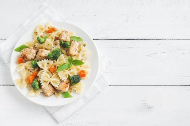 Farfalle makarna Tavuk ve sebze ile. Beyaz ahşap arka planda, kopya alanı makarna salatası.