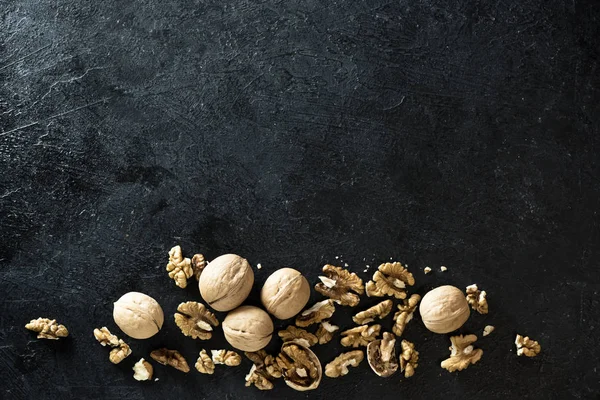 Organik ceviz. Ceviz sınır siyah taş zemin, üstten görünüm, kopya alanı.
