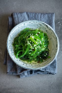 Chuka yosun salata üzerine beton arka plan, seramik kase alanı kopyalayın. Japon mutfağı - Chuka salata